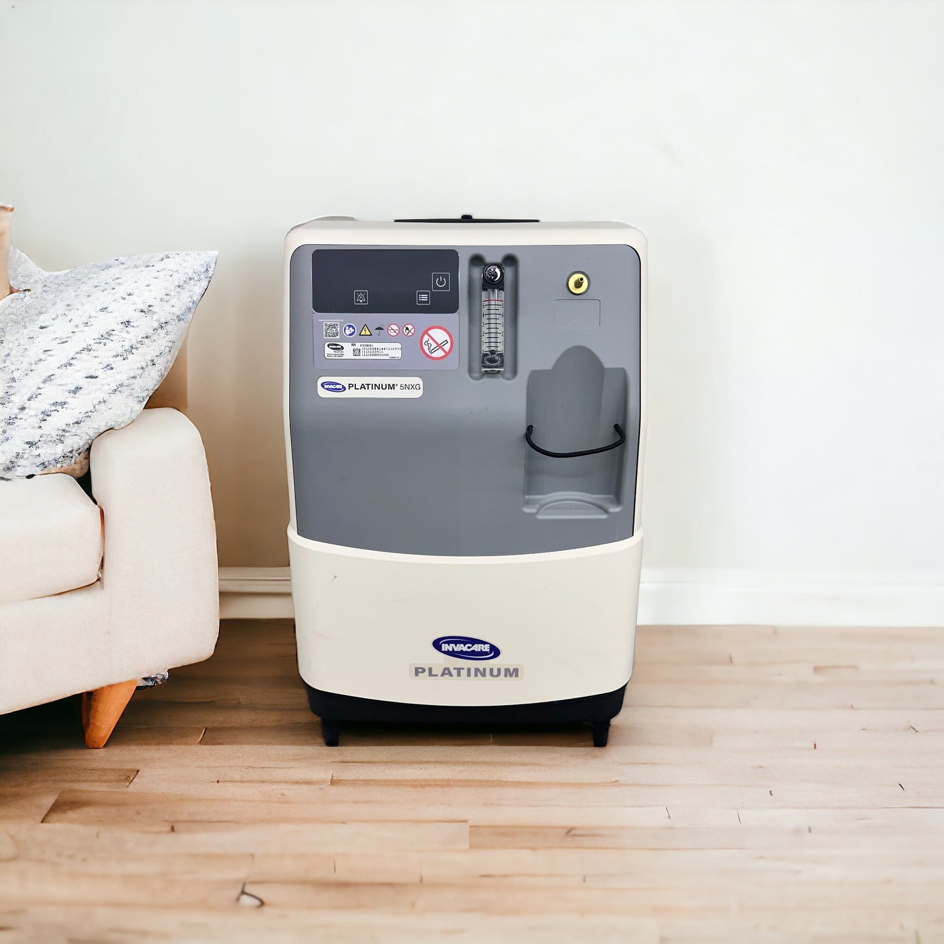 nvacare 5NXG Oxygen Concentrator in a room next to a sofa